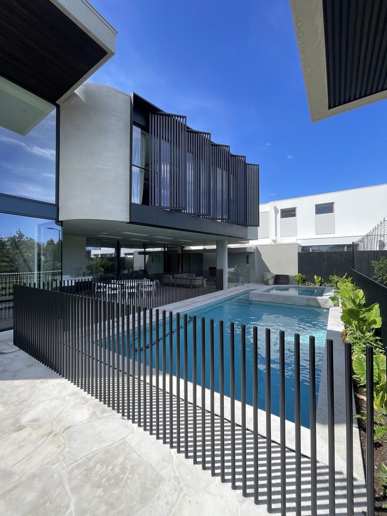 Black rod pool fence at a modern home